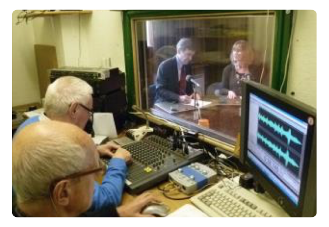 people in a studio recording for the talking newspaper