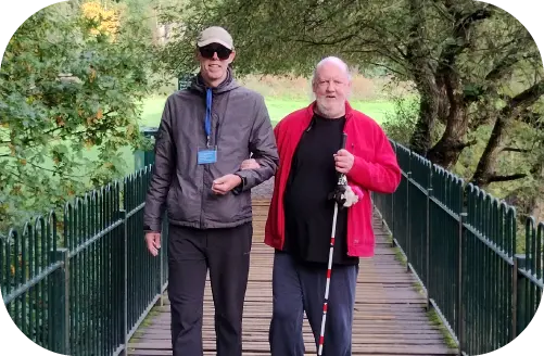 A volunteer helping a person suffering from sightloss